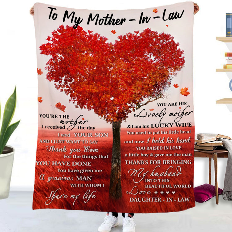 a person holding a blanket with a heart shaped tree