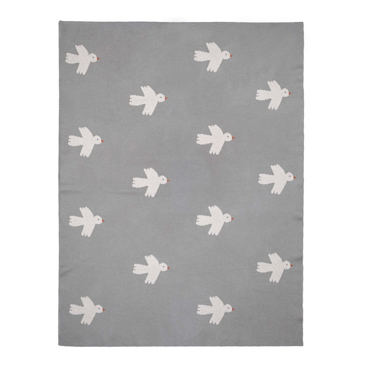 a grey rug with white birds on it