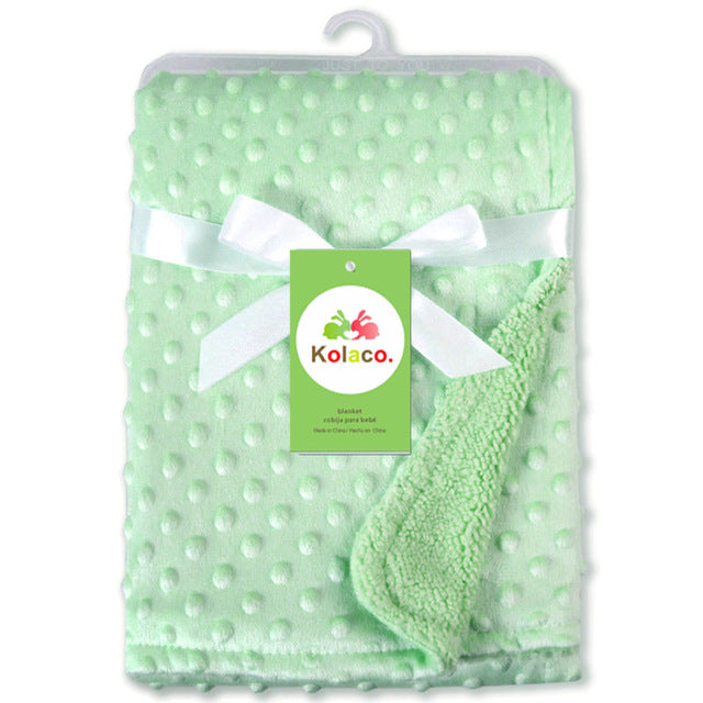 a green blanket with a white bow