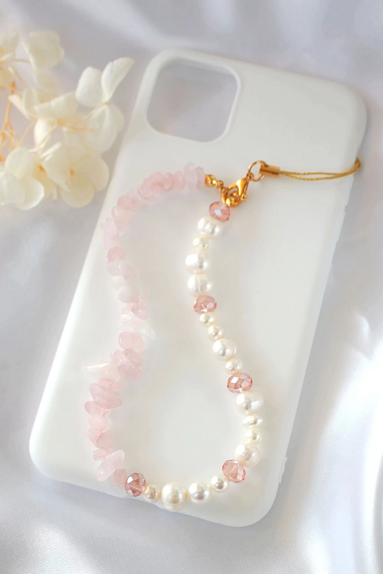 a phone case with a necklace on it