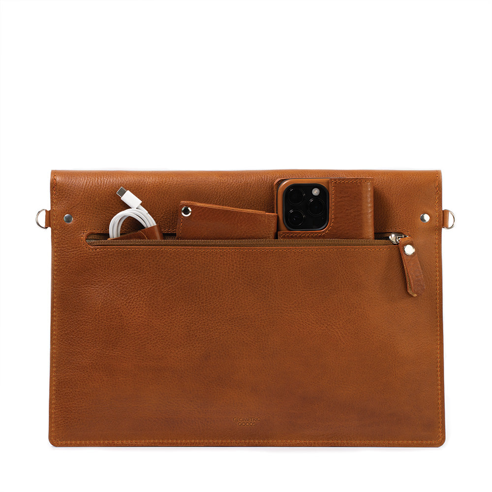 a brown leather bag with a phone and a phone in it