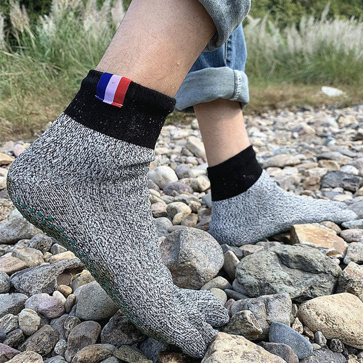 a person's feet in a rocky area