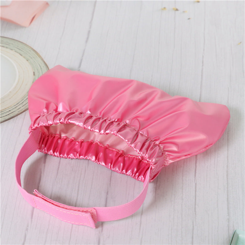 a pink hair cap on a white surface