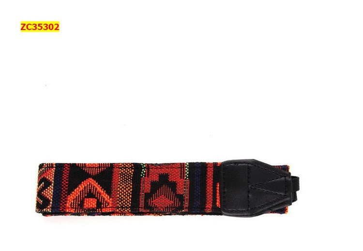 a colorful fabric strap with a black leather strap