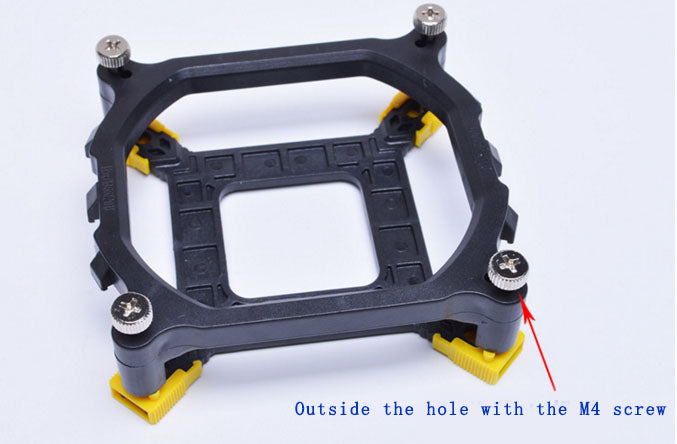 a black and yellow square object with screws