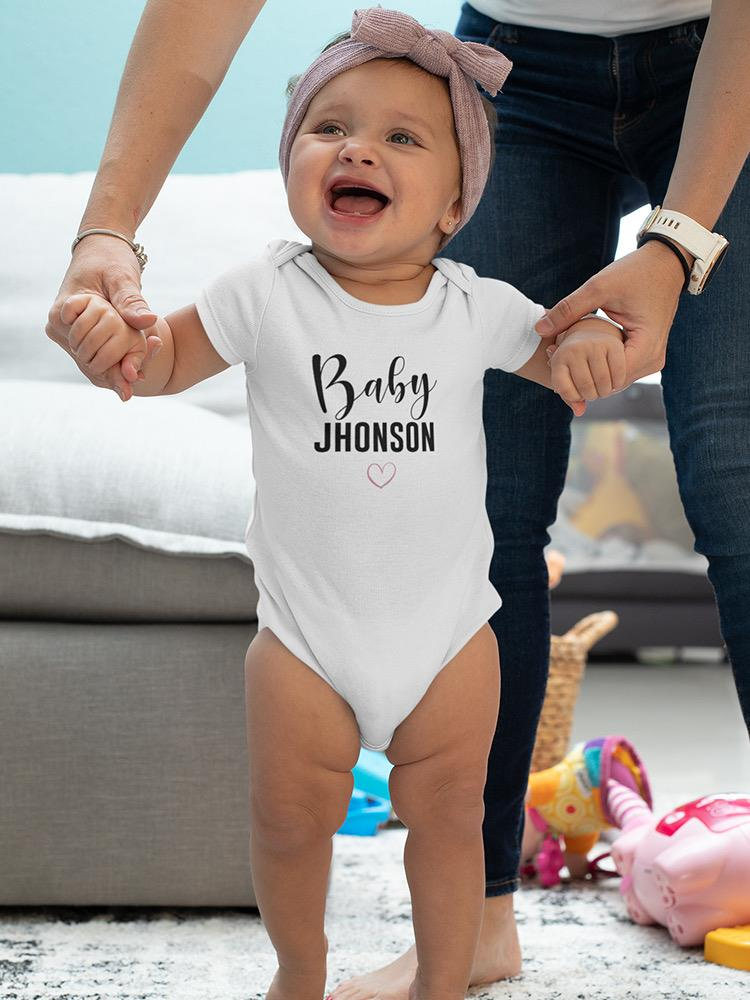 a baby standing in front of a person's hand