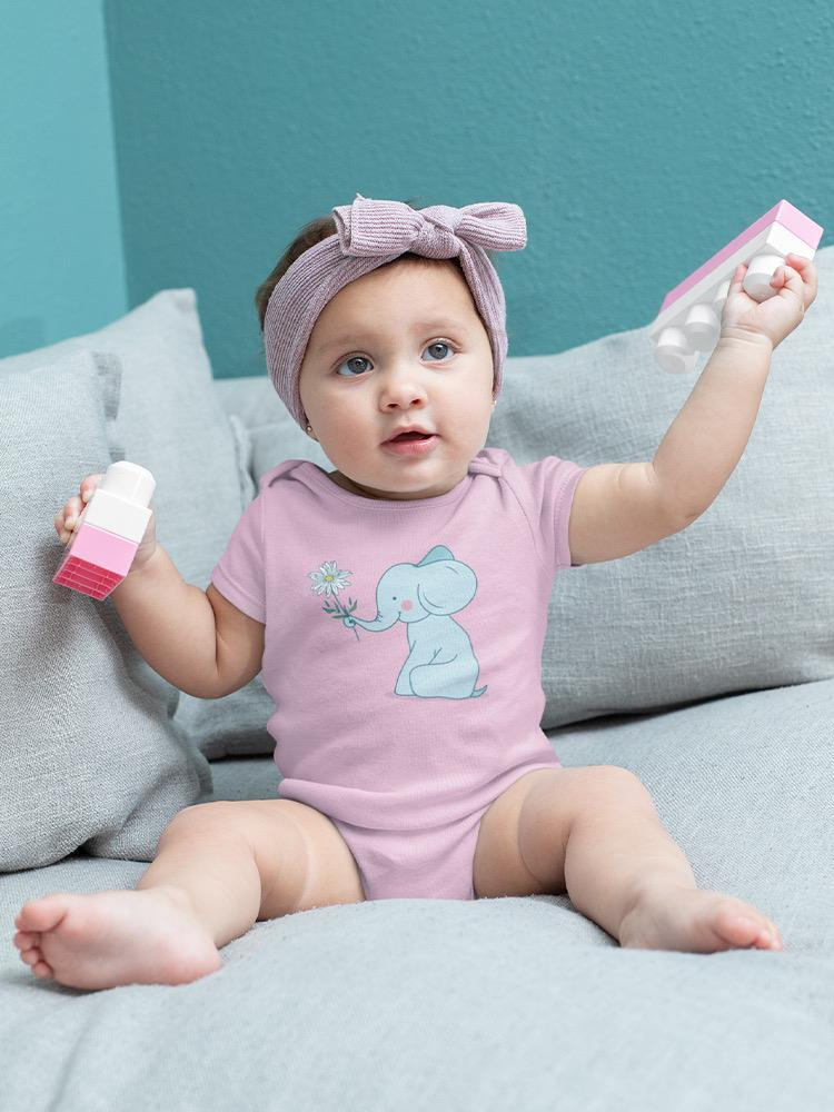 a baby holding a toy