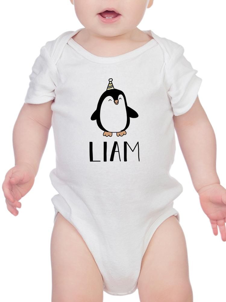 a baby wearing a white bodysuit with a penguin on it