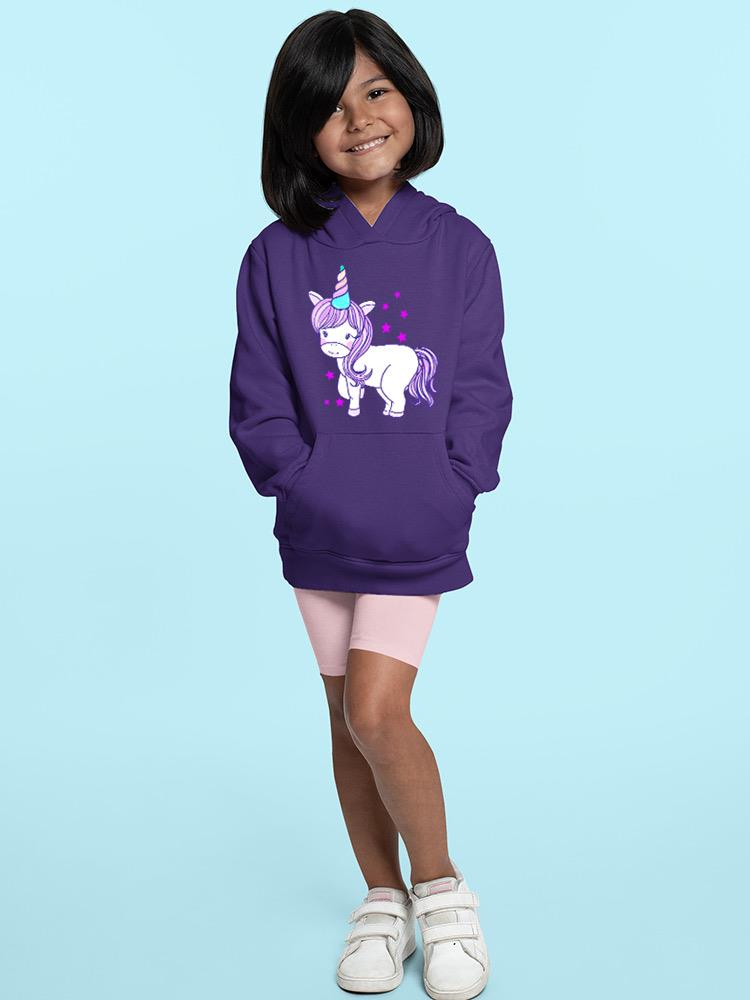 a girl standing in a purple hoodie with a unicorn on it
