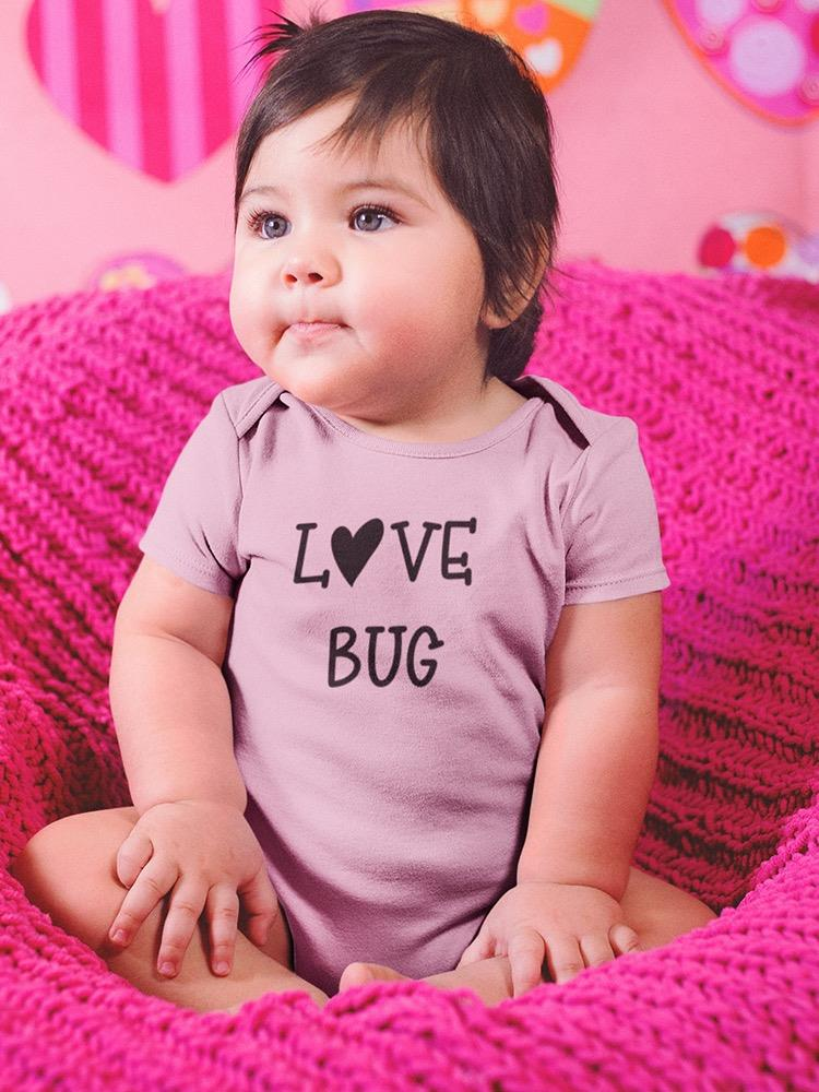 a baby sitting on a pink blanket