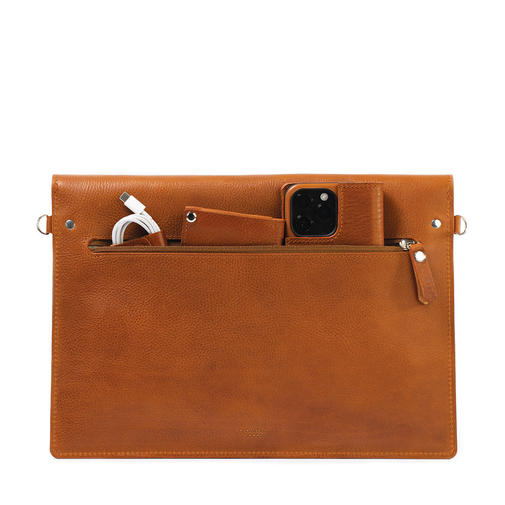 a brown leather bag with a phone and a watch inside