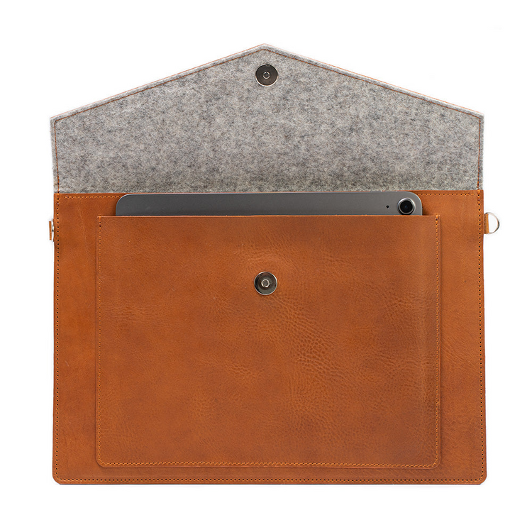 a brown leather bag with a tablet in it