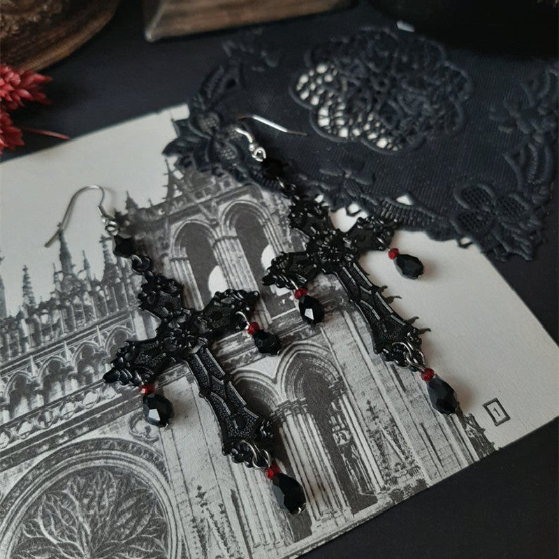 a pair of earrings on a piece of paper