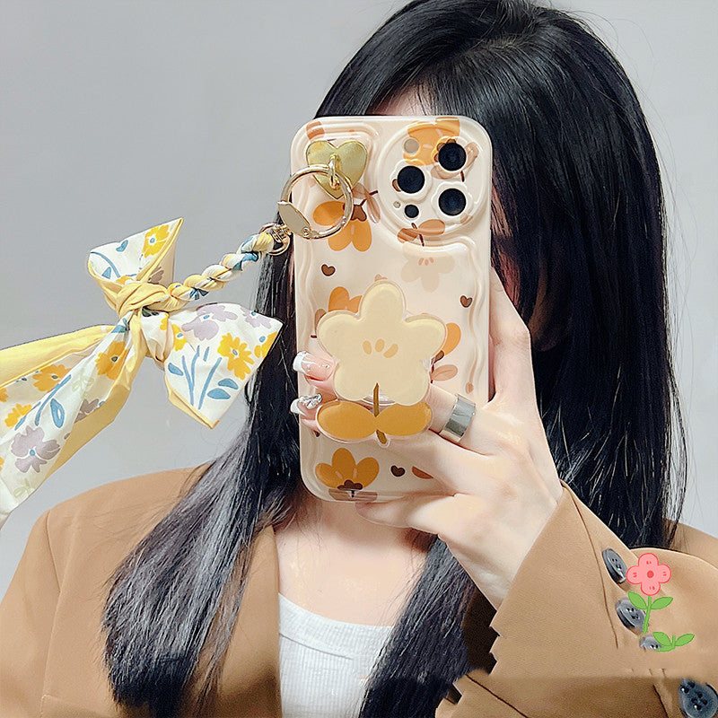 a woman holding a phone case