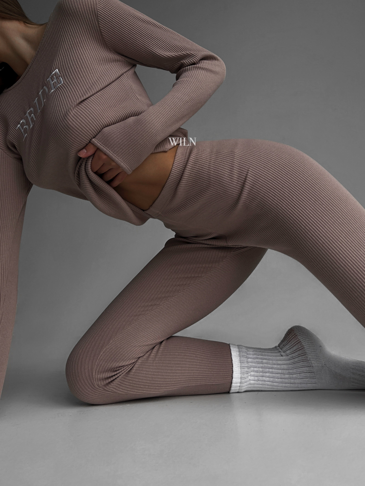 a woman in a brown outfit