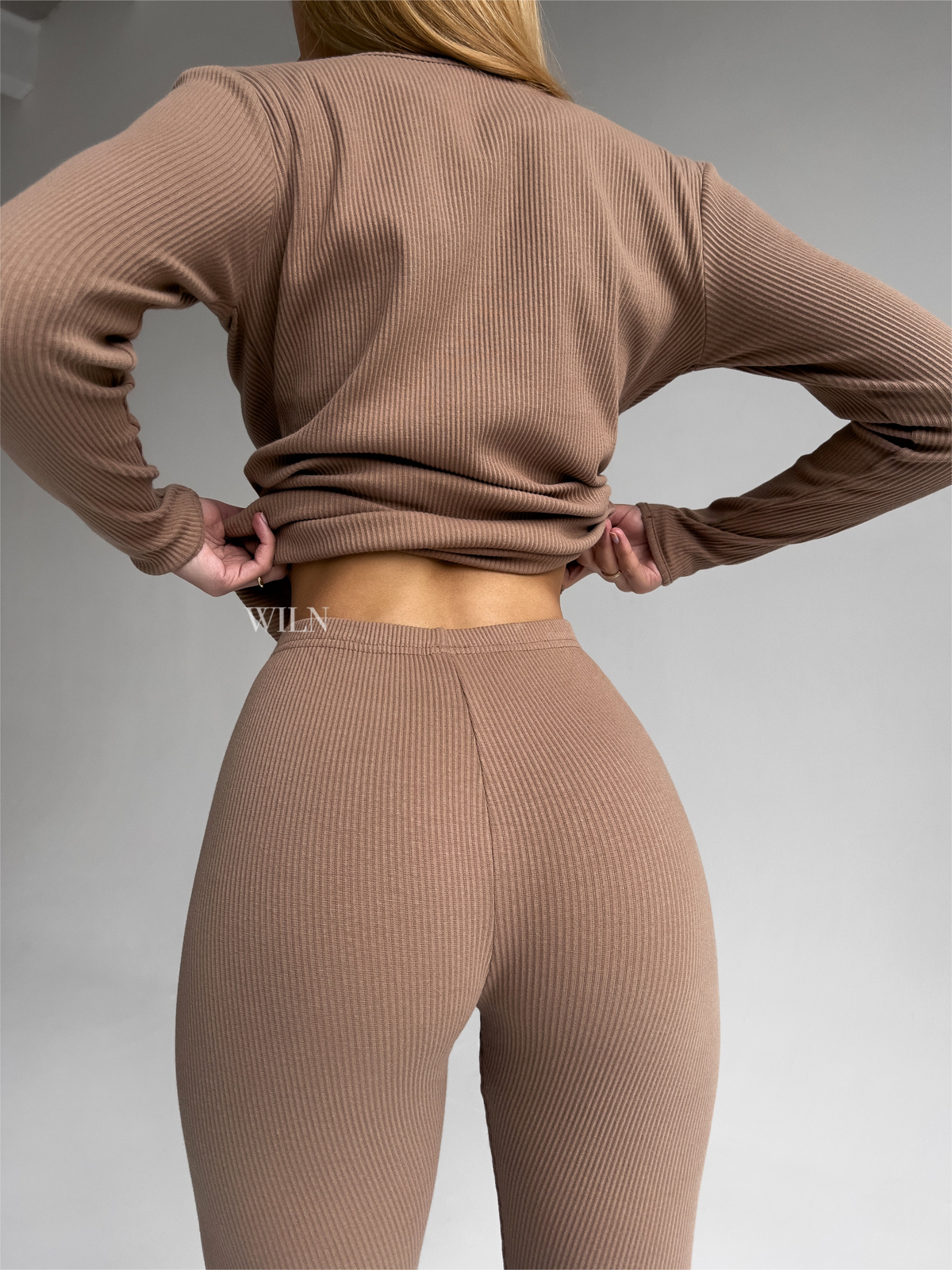 a woman in a brown sweater
