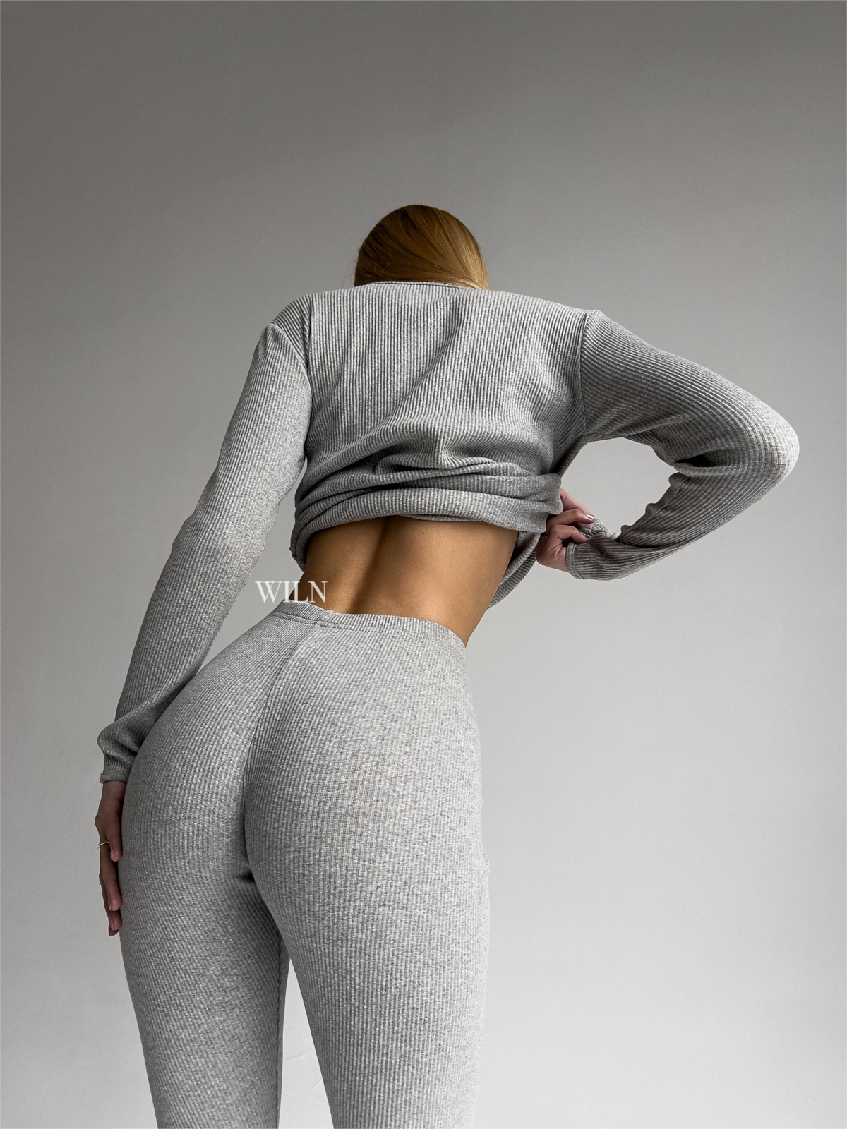a woman in a grey outfit