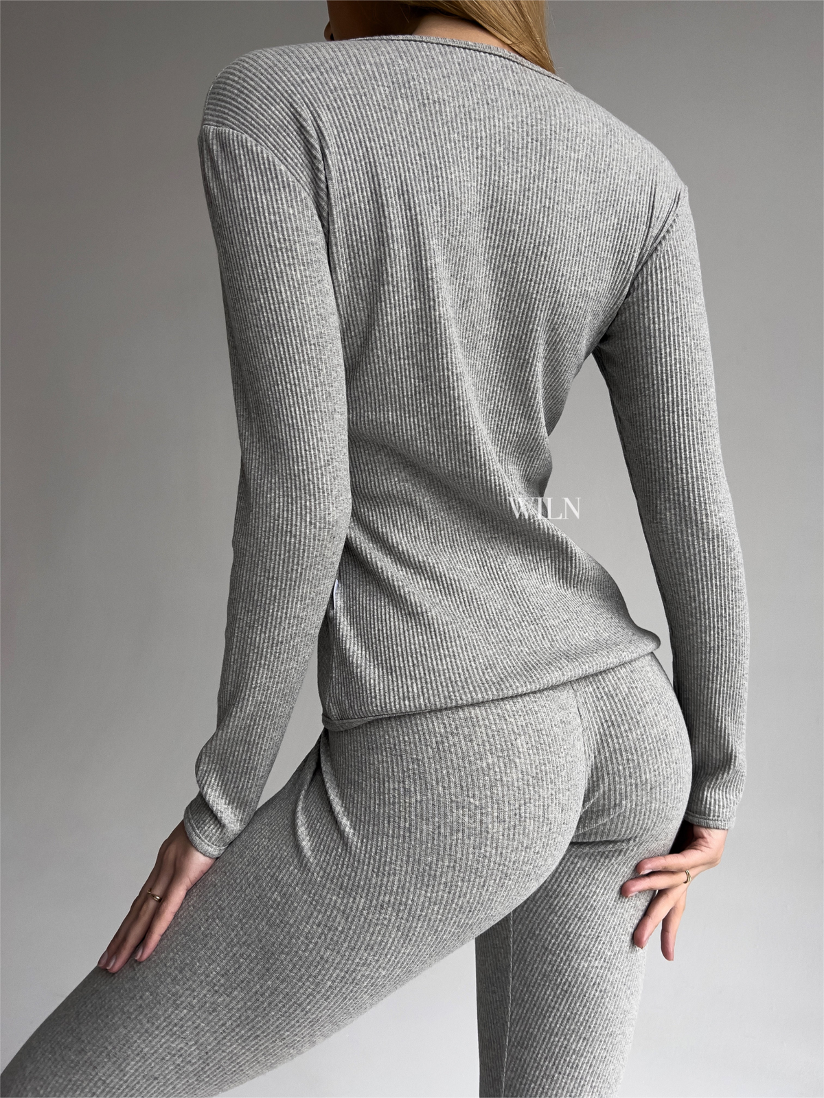 a woman in a grey outfit