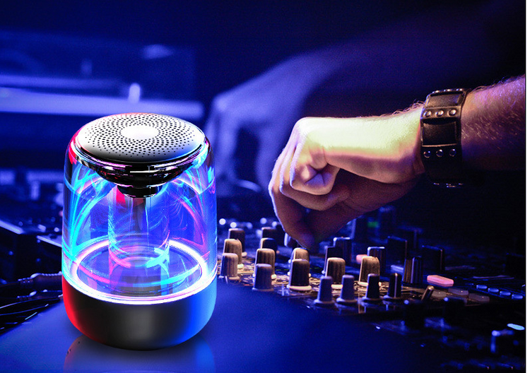 a hand pressing a button on a sound mixer
