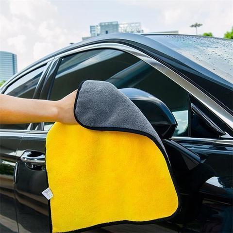 a hand holding a yellow and grey towel