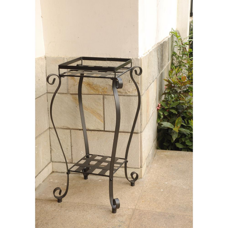 a metal plant stand on a stone surface