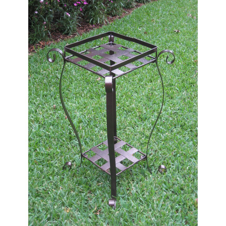 a metal plant stand in the grass