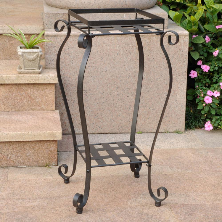 a metal plant stand on a stone surface