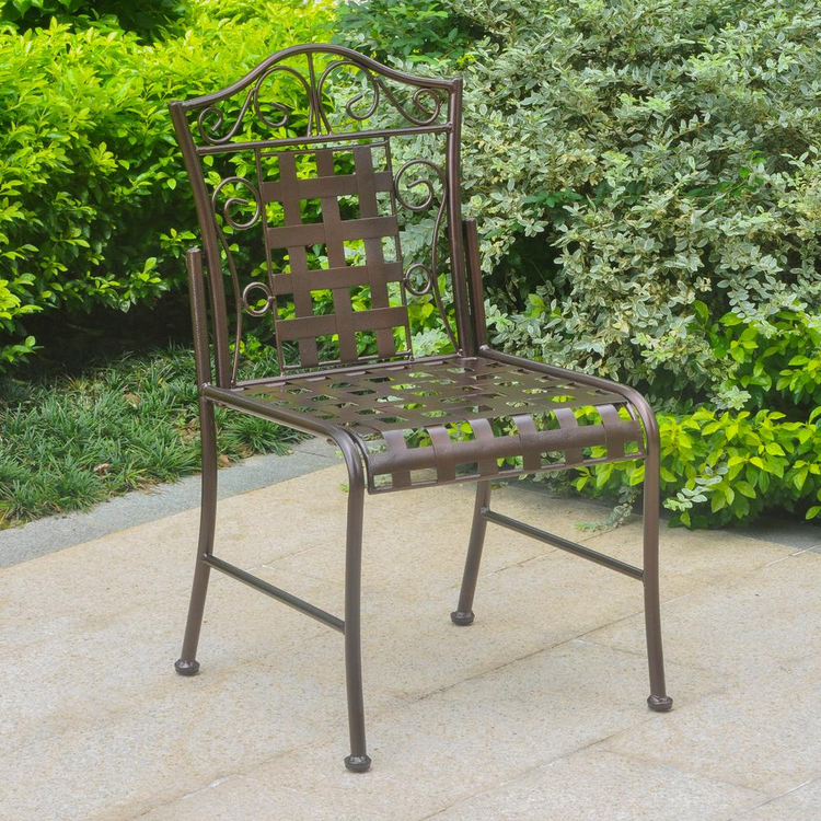 a chair outside with bushes in the background