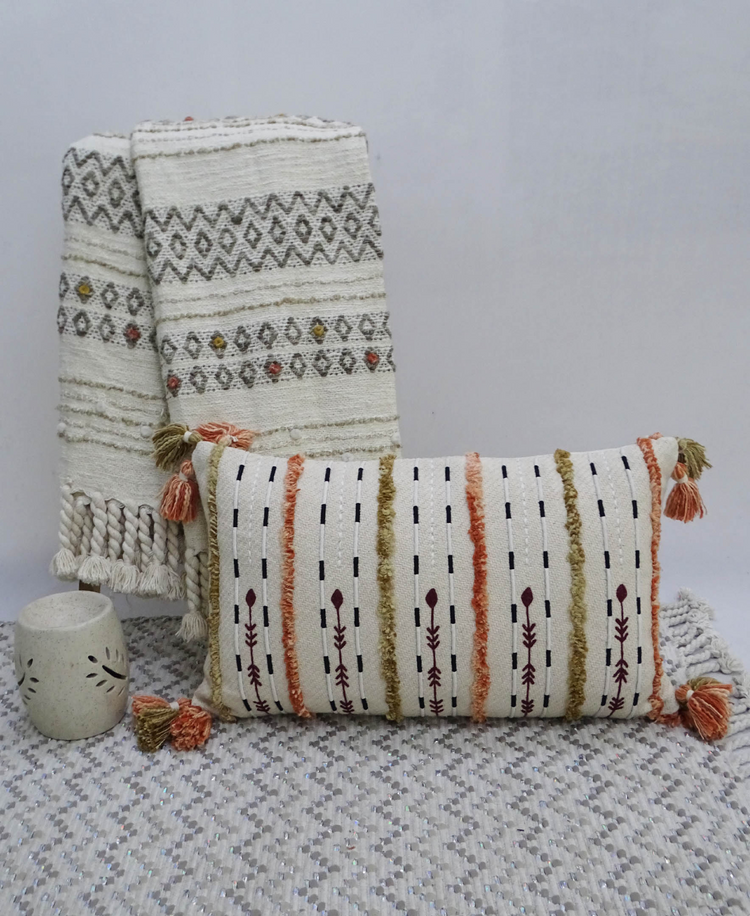 a pillow and blanket on a rug