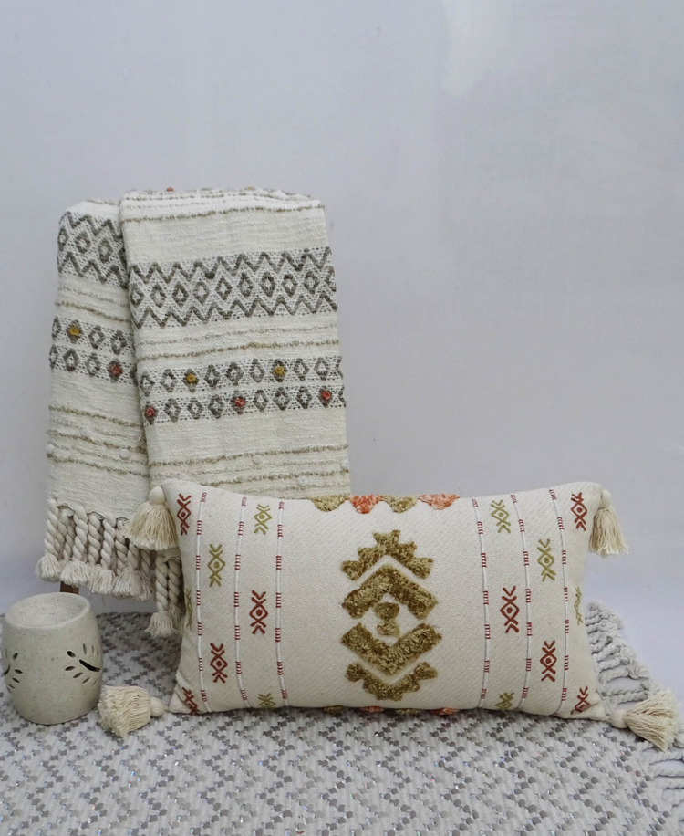 a pillow and blanket on a rug