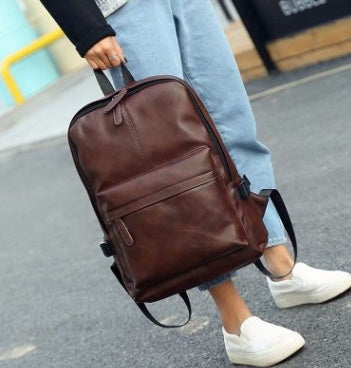 a person carrying a brown backpack