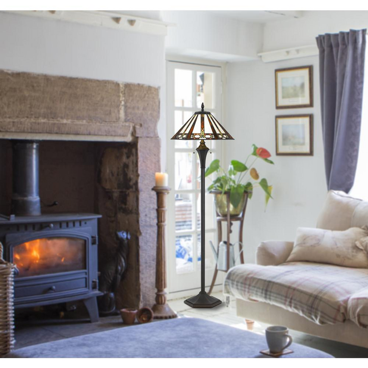 a living room with a fireplace and a lamp