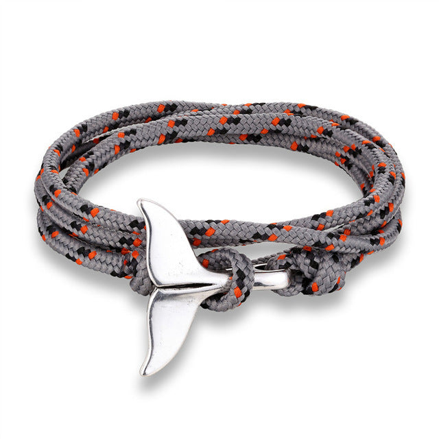 a bracelet with a silver fin on it