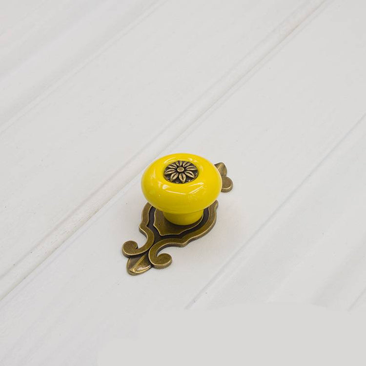 a yellow door knob on a white surface