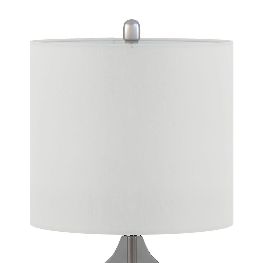 a white lamp shade with a silver base