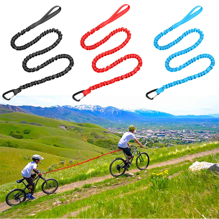 a couple of people riding bikes on a trail with a leash