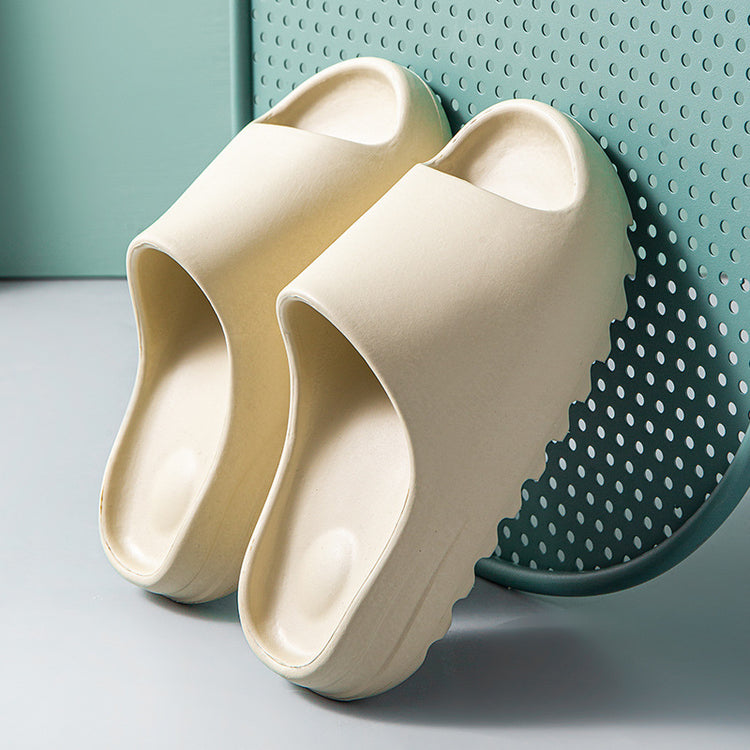 a pair of white slippers leaning against a blue wall