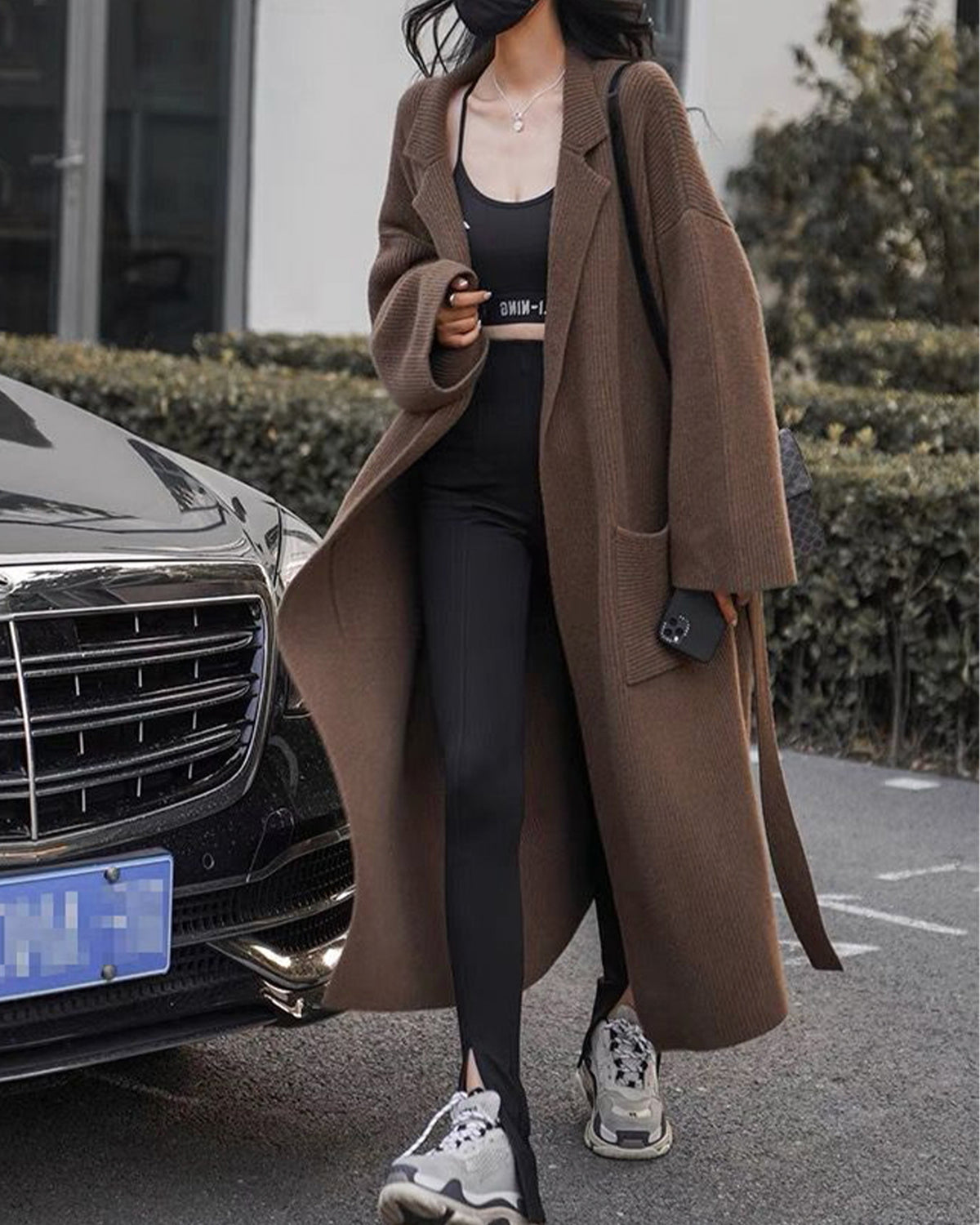 a woman in a long coat