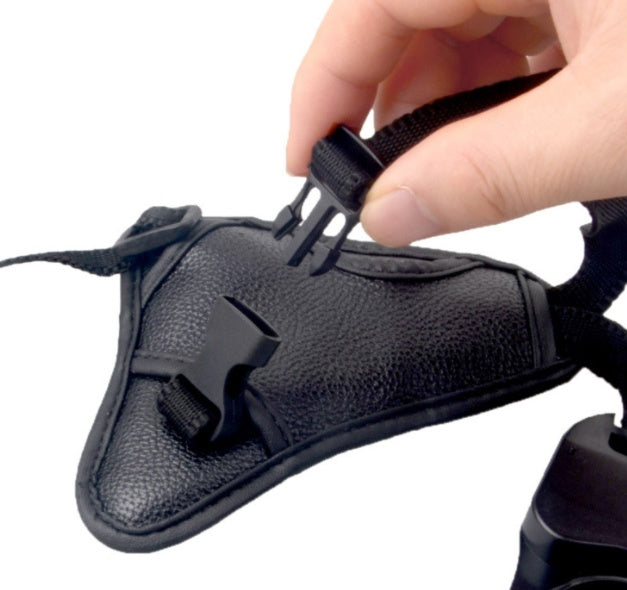a hand holding a strap