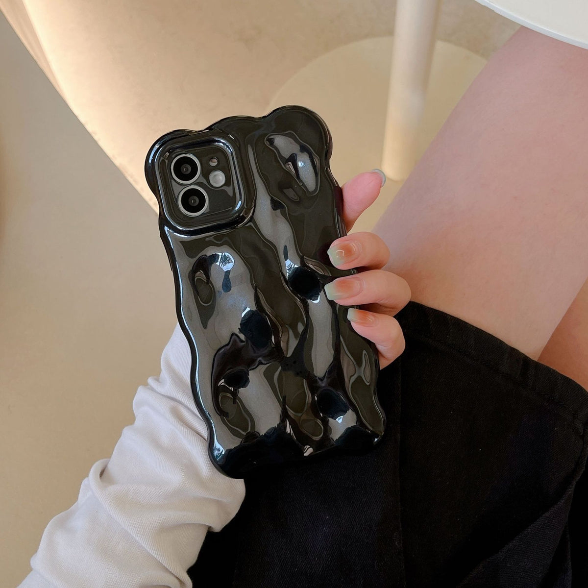 a person holding a phone case