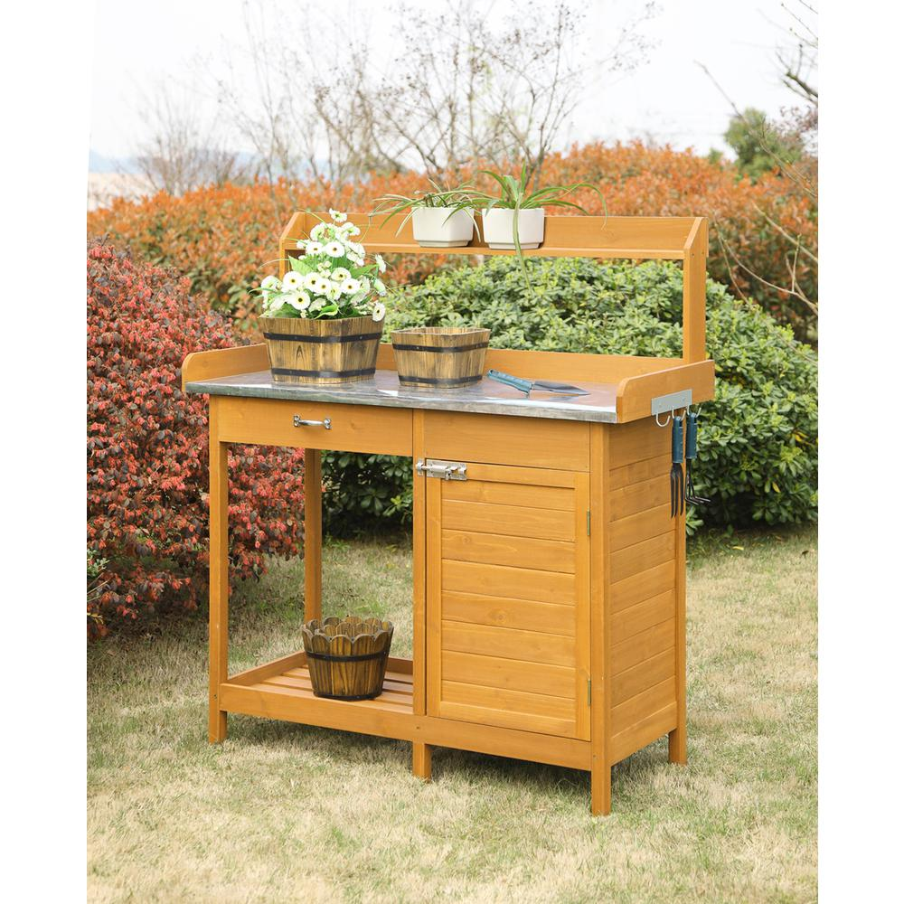a wooden potting table with potted plants on top