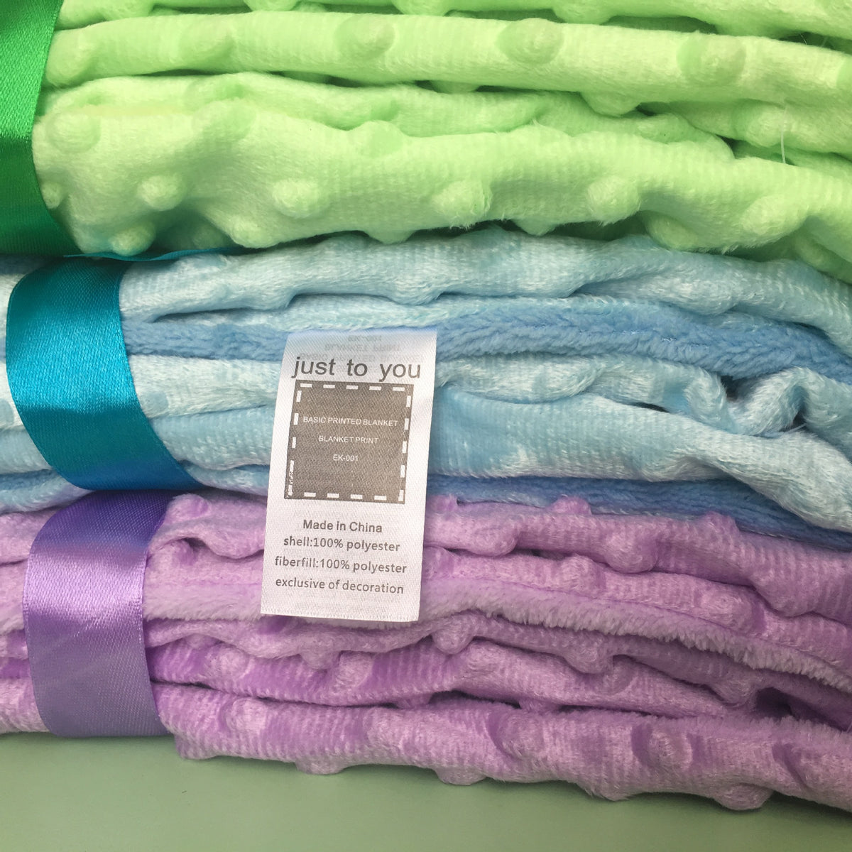 a stack of blankets with a label