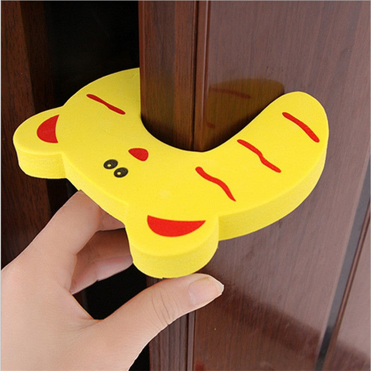 a hand holding a yellow object