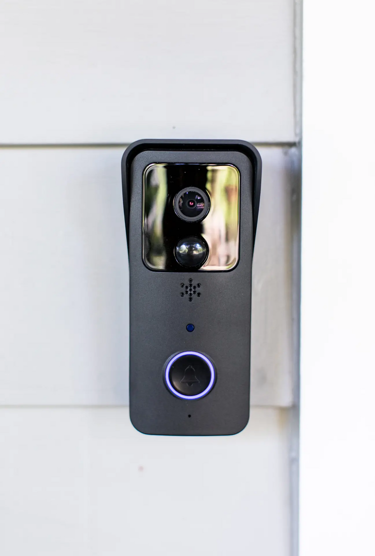 a black video camera on a white wall