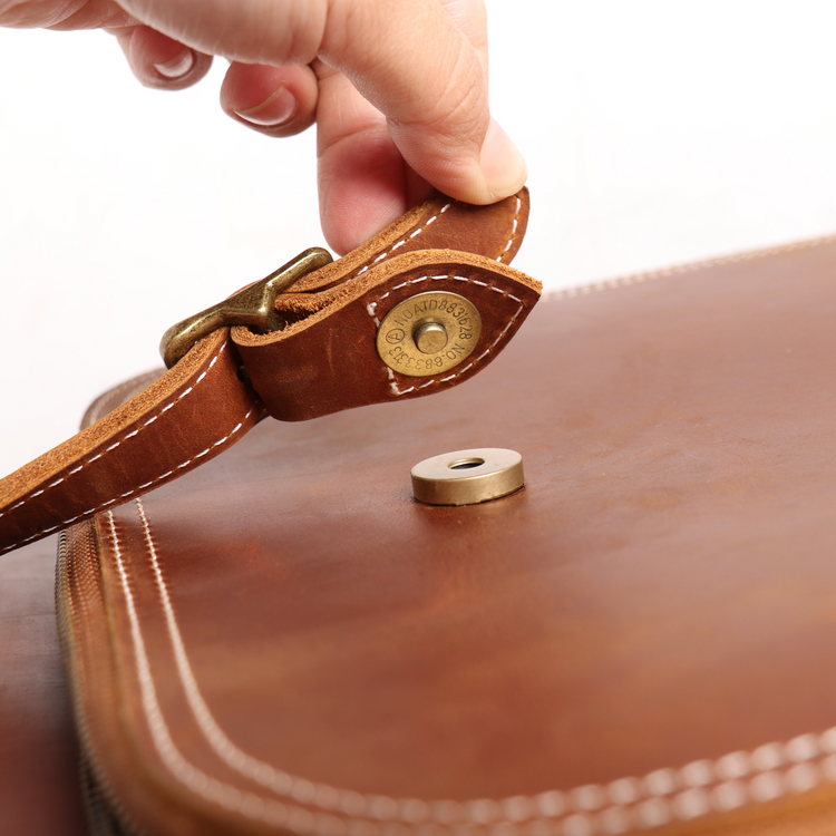 a hand holding a leather strap