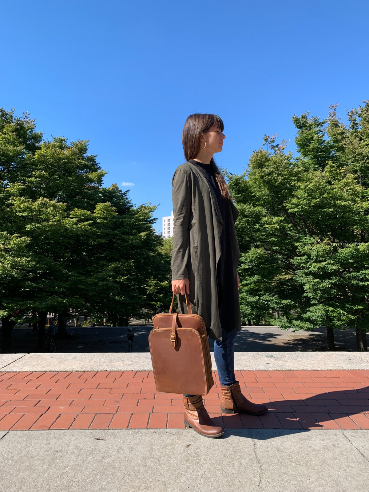 a woman holding a brown suitcase