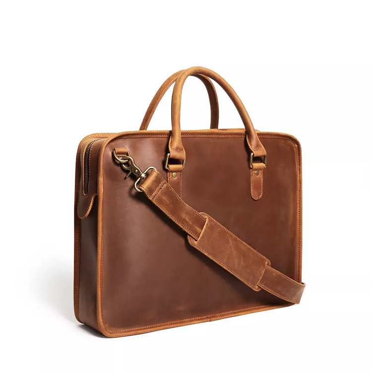 a brown leather briefcase with a strap