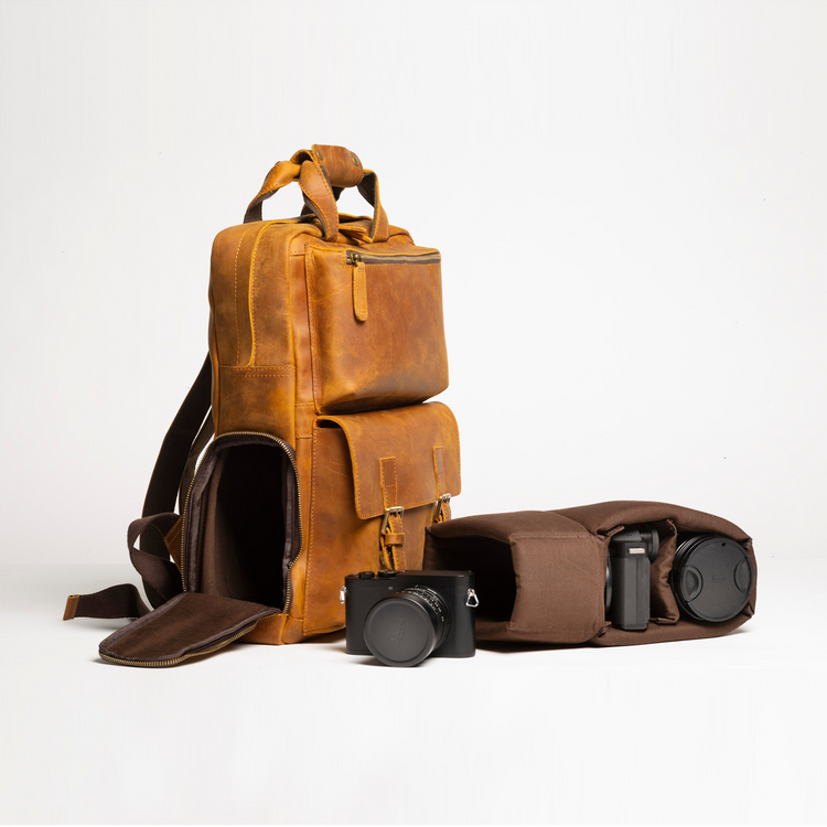 a brown leather bag with a camera case