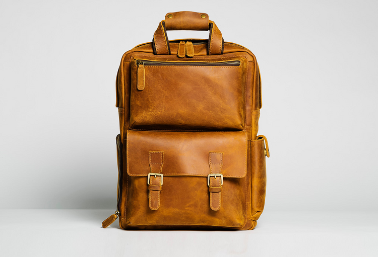 a brown leather backpack with a zipper