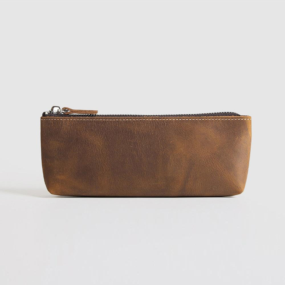 a brown leather pouch on a white surface
